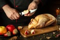 The cook cuts apples to add to raw duck before frying. Cooking a national dish or Peking duck in the restaurant kitchen by the