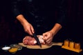 The cook cuts the fat on the neck, prepares the meat for marinating and roasting Royalty Free Stock Photo