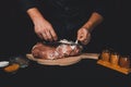 The cook cuts the fat on the neck, prepares the meat for marinating and roasting Royalty Free Stock Photo