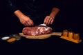 The cook cuts the fat on the neck, prepares the meat for marinating and roasting Royalty Free Stock Photo