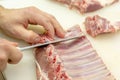 The cook cuts the lamb loin along the ribs Royalty Free Stock Photo