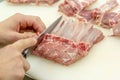 The cook cuts the lamb loin along the ribs Royalty Free Stock Photo