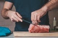 Cook cuts a large piece of pork
