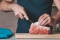 The cook cuts the pork ribs into pieces for cooking Royalty Free Stock Photo