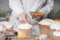 A cook decorates pastries in the dining room