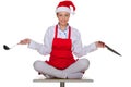 Cook with dishes in the cap of Santa Claus Royalty Free Stock Photo