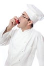 Cook eating red apple Royalty Free Stock Photo