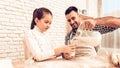 Man near Girl Pours Milk into Glases with Dough.