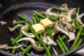 Cook fry oyster mushrooms with green string beans in a frying pan Royalty Free Stock Photo