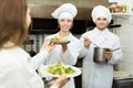 Cook gives to waitress plates Royalty Free Stock Photo