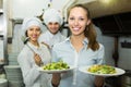 Cook gives to waitress plates Royalty Free Stock Photo