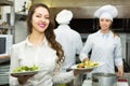 Cook gives to waitress plates Royalty Free Stock Photo