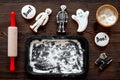 Cook halloween gingerbread cookies bat, skeleton, ghost. Sweets neat rolling pin and baking sheet. white background top