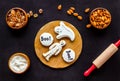 Cook halloween gingerbread cookies on black background top view