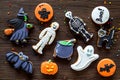 Cook halloween gingerbread cookies with witch, skeleton, ghost. wooden background top view