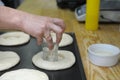 Cook hand forming dough with a glass for further making cakes