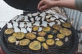 Cook hand pours spices on grilled vegetables