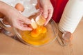 Cook hands adds eggs into dish