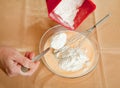 Cook hands adds flour into dish Royalty Free Stock Photo