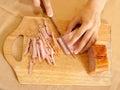 Cook hands cutting bacon