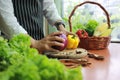 Cook hands holding cauliflower and yellow bell pepper in kitchen table Royalty Free Stock Photo