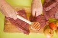 Cook hands making tenderized steak Royalty Free Stock Photo