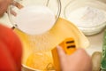 Cook hands pouring sugar into bowl Royalty Free Stock Photo