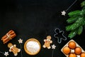 Cook homemade gingerbread cookies for New Year party. Eggs, flour, cinnamon near gingerbread man and spruce branch on Royalty Free Stock Photo