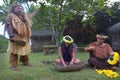 Cook Islander tribal chief stands beside two Cook Islander women