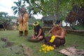 Cook Islander tribal chief stands beside two Cook Islander women