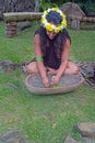 Cook Islander woman mashing plants and herbs for herbal medicine