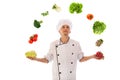 Cook juggling with fresh vegetables Royalty Free Stock Photo