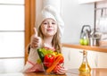 Cook kid with vegetables at kitchen Royalty Free Stock Photo