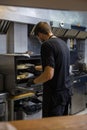 cook in the kitchen of a restaurant preparing food with hygienic measures