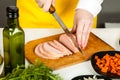 Cook knife cuts sausage Royalty Free Stock Photo