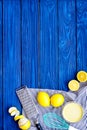 Cook lemon curd. Sweet cream in bowl, fruits, kitchen utensils grater and whisk on blue wooden background top view copy Royalty Free Stock Photo