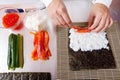 Cook making Japanese sushi rolls