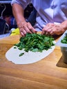 Cook making Turkish Gozleme, a traditional Anatolian stuffed fla