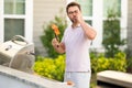 Cook man preparing barbecue grill outdoor. Man cooking tasty salmon on barbecue grill at backyard. Man chefs with sign Royalty Free Stock Photo