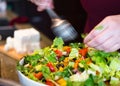 The cook mixes salad of sliced leaves and vegetables seasoned wi Royalty Free Stock Photo