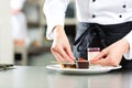 Cook, pastry chef, in hotel or restaurant kitchen Royalty Free Stock Photo