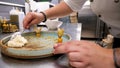 Cook pouring mashed potates in a plate