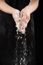 Cook pouring wheat white flour, hands close-up Royalty Free Stock Photo
