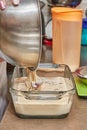 The cook pours the dough for making cherry pie in a transparent form into the oven. Let's prepare a delicious