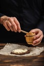 The cook pours honey on bread