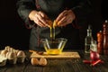 The cook pours a raw egg into a bowl. The idea of making a delicious omelet for breakfast. Working environment in a restaurant