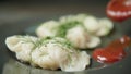 Cook pours the sauce on the boild dumplings