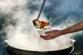 The cook pours soup in a bowl. Royalty Free Stock Photo