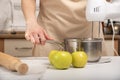 Cook prepares an apple pie. Mixer mixes the ingredients in saucepan