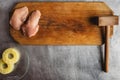 Cook prepares chicken on a wooden cutting board, chicken, pineapple, meat tenderizer. recipe for chicken fillet with cheese and Royalty Free Stock Photo